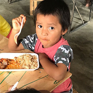 Poor child receiving help through our community involvement and outreach.